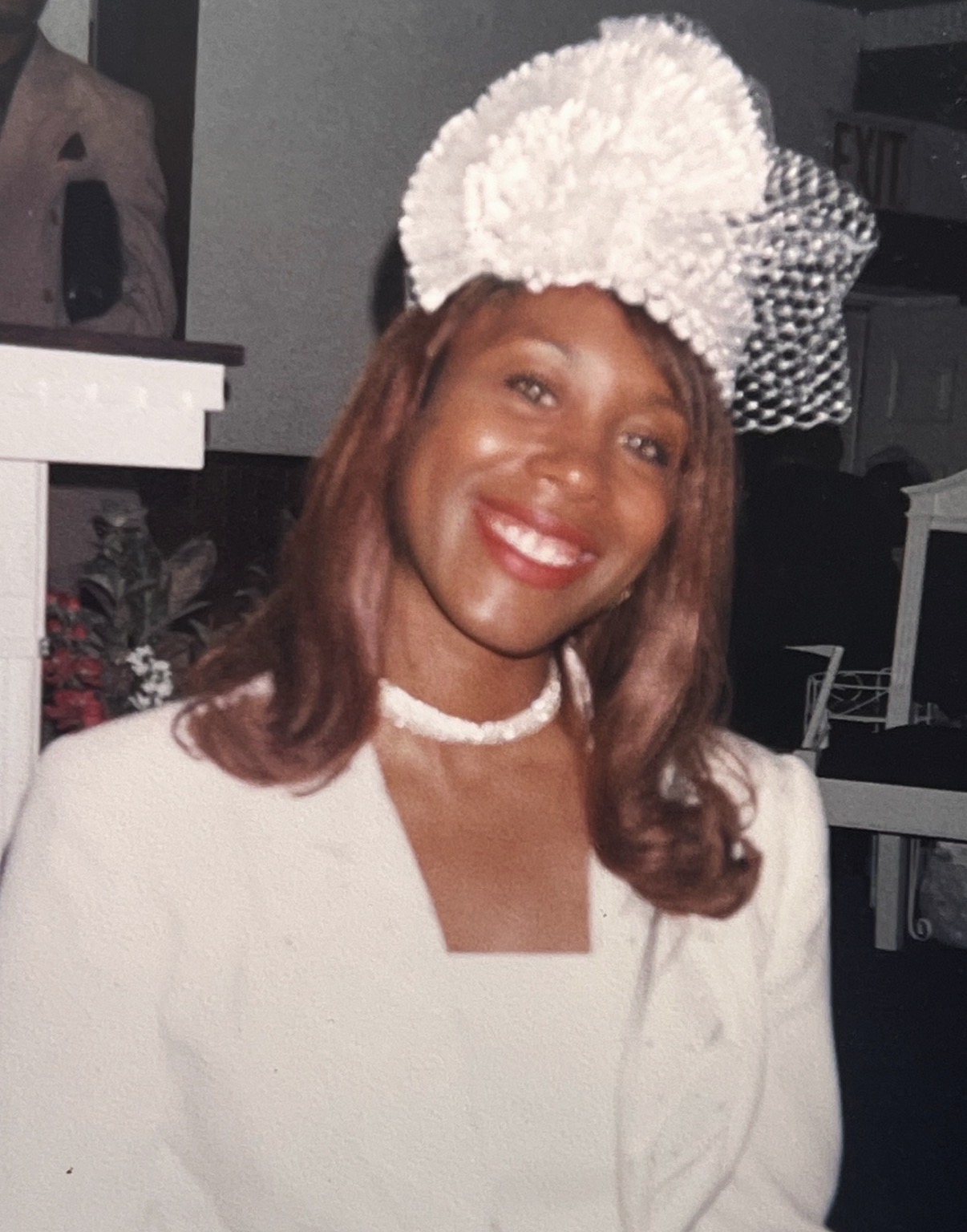 A young Mary Kingcannon in an elegant white suit and white pom-pom hat with veil