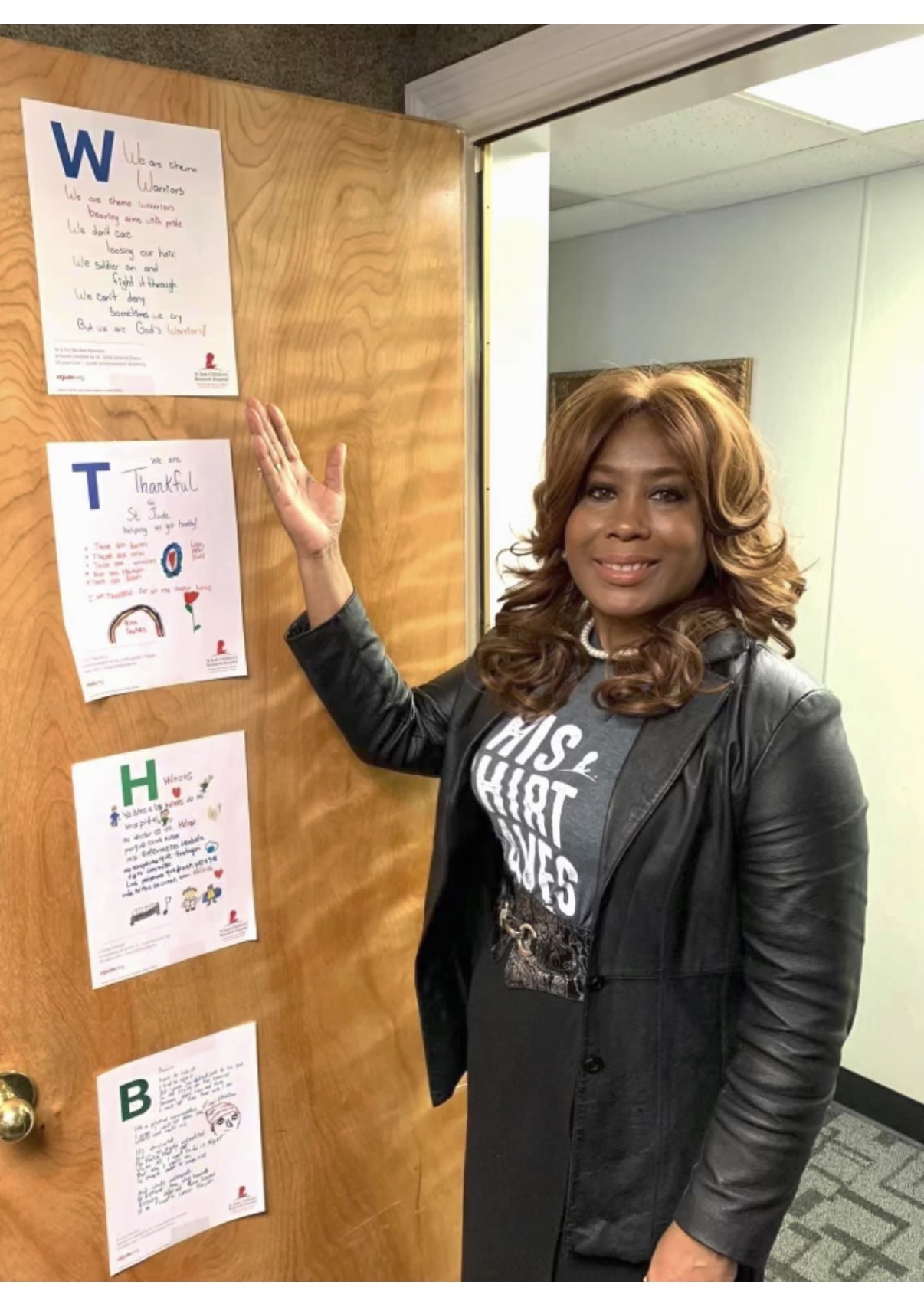 Mary at St. Jude beside the 'Chemo Warriors' hallway tributes