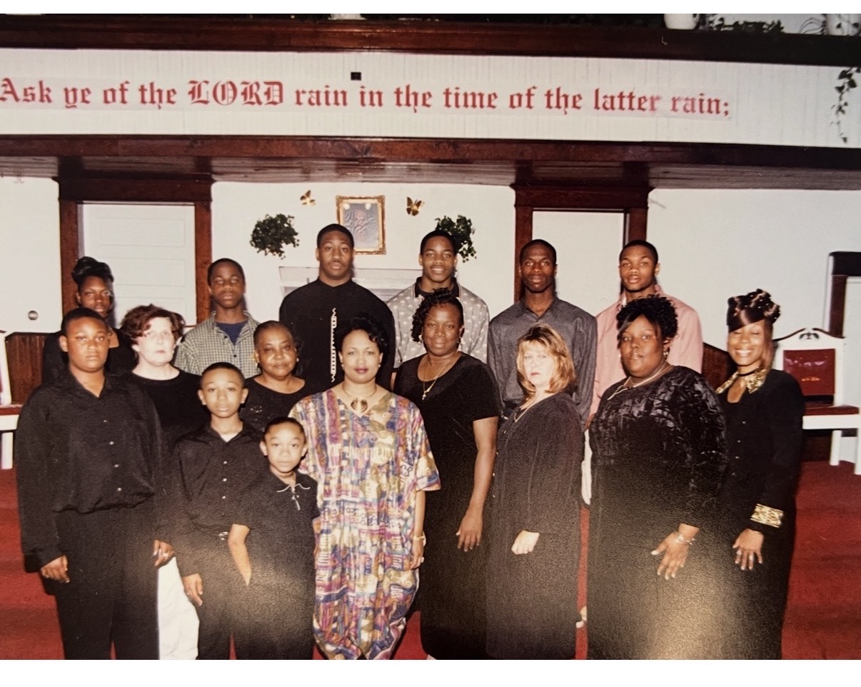 Mary with her church family beneath the 'Ask ye of the LORD' sanctuary banner
