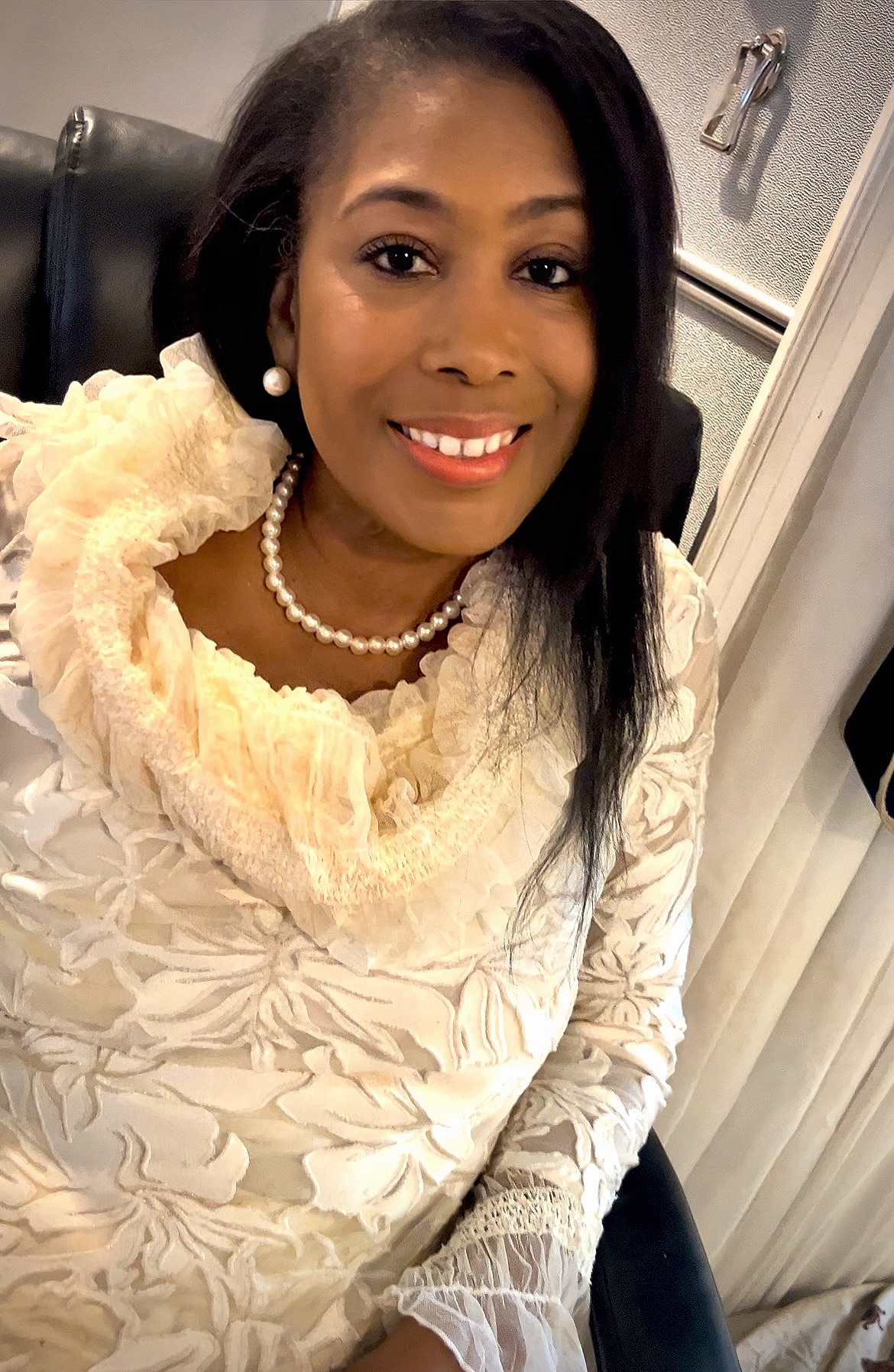 First Lady Mary Kingcannon in a cream ruffled blouse and pearls