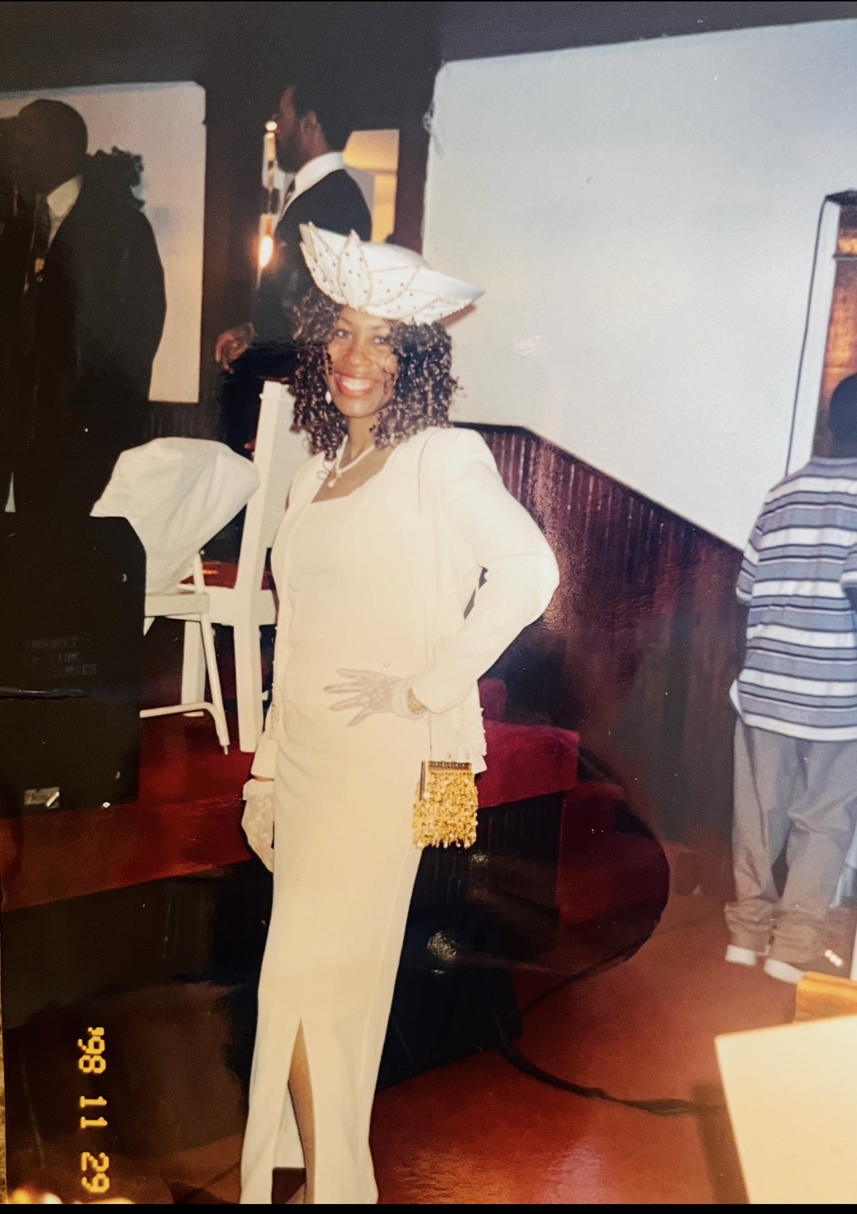 Mary Kingcannon in a white suit and beaded white hat, 1998