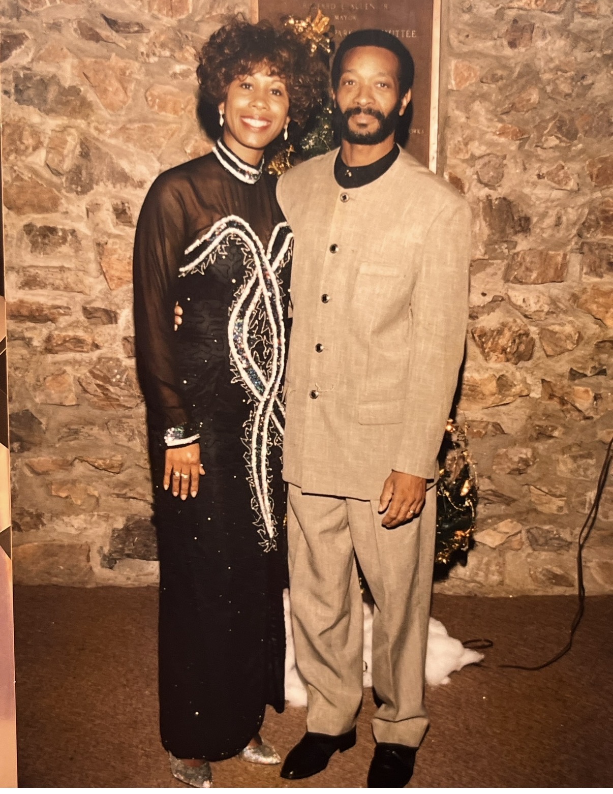 Mary in a beaded black gown with her husband David Kingcannon at Christmas